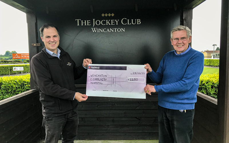 Wincanton Racecourse General Manager, Jack Parkinson, presents a cheque to Alan Judge, Treasurer of The Friends of Wincanton Community Hospital