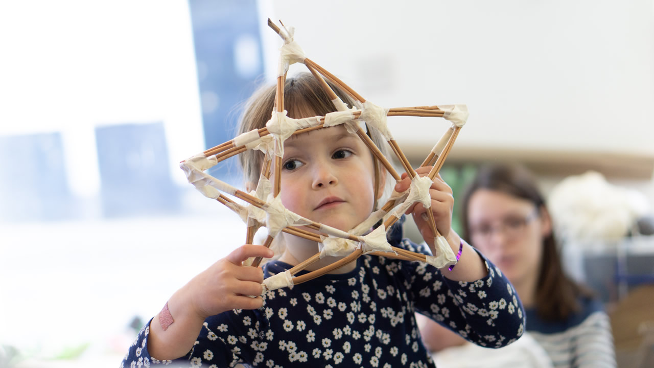 A Wincanton child holding a willow lantern frame at Bootmakers Workshop