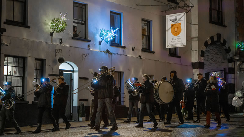 Wincanton Silver Band leading the 2021 Christmas lantern parade passed The Bear Inn