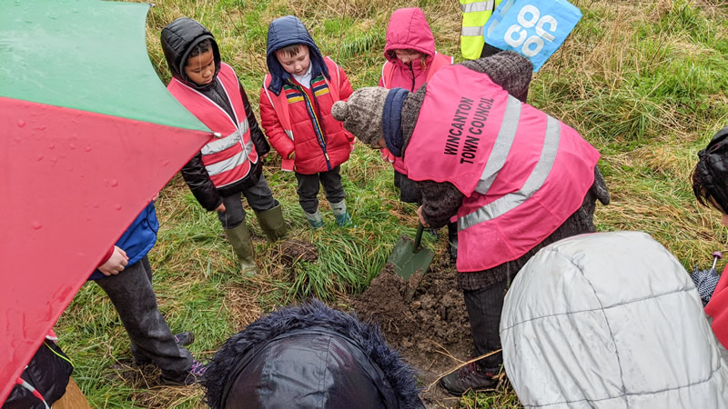 Children from Our Lady of Mount Carmel Primary School planting an oak sapling