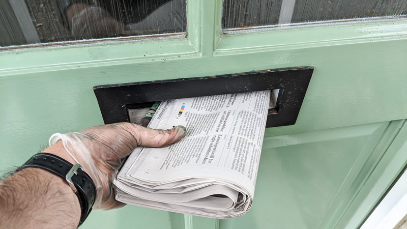 Delivering a newspaper